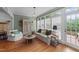 Cozy living room featuring hardwood floors, natural light, and comfortable seating at 5308 Stableview Ct, Holly Springs, NC 27540