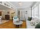 Bright living room features hardwood floors, neutral colors, comfortable seating, and abundant natural light at 5308 Stableview Ct, Holly Springs, NC 27540