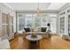 Bright living room featuring wood floors, comfortable seating, and large windows at 5308 Stableview Ct, Holly Springs, NC 27540