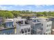 Aerial view of modern townhouses with rooftop decks and city views in a vibrant community at 610 Velma Hopkins Ln, Raleigh, NC 27603