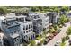 Street view of contemporary townhomes with rooftop terraces, landscaping, and convenient street parking at 610 Velma Hopkins Ln, Raleigh, NC 27603