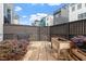 Private backyard with garden beds, a brick path, and a wood fence at 610 Velma Hopkins Ln, Raleigh, NC 27603