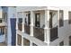 Elegant balcony with black railings and white columns, offering a cozy spot to relax outdoors at 610 Velma Hopkins Ln, Raleigh, NC 27603