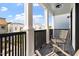 Outdoor balcony with rocking chairs, black metal railings and neighborhood views at 610 Velma Hopkins Ln, Raleigh, NC 27603