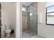 Modern bathroom with a glass walk-in shower and window at 610 Velma Hopkins Ln, Raleigh, NC 27603