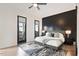 Modern bedroom featuring a black accent wall, a ceiling fan and french doors to a balcony at 610 Velma Hopkins Ln, Raleigh, NC 27603
