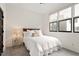 Bright bedroom with large windows, neutral decor, and a simple, modern design at 610 Velma Hopkins Ln, Raleigh, NC 27603