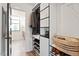 Modern walk-in closet with custom shelving and access to an ensuite bathroom at 610 Velma Hopkins Ln, Raleigh, NC 27603