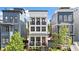 Charming three-story home with a welcoming front porch, black trim, and a bright red front door at 610 Velma Hopkins Ln, Raleigh, NC 27603