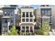 Beautiful three-story home with a welcoming porch featuring swing chairs and an eye-catching red door at 610 Velma Hopkins Ln, Raleigh, NC 27603