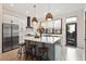 Modern kitchen featuring a large island, stainless steel appliances, white cabinets and subway tile backsplash at 610 Velma Hopkins Ln, Raleigh, NC 27603