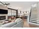Open-concept living room flows seamlessly into the dining area, featuring a cozy fireplace and hardwood floors at 610 Velma Hopkins Ln, Raleigh, NC 27603