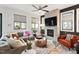 Bright living room featuring a stylish fireplace, plush seating, and large windows at 610 Velma Hopkins Ln, Raleigh, NC 27603