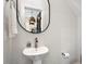 Stylish powder room features a pedestal sink, modern mirror, and neutral color scheme at 610 Velma Hopkins Ln, Raleigh, NC 27603