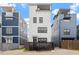 Three-story house with a modern design, showcasing a private fenced yard and rooftop terrace potential at 610 Velma Hopkins Ln, Raleigh, NC 27603