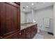 Bathroom featuring double vanity with granite countertops, wood cabinets, and a large mirror at 618 N Boylan Ave # 810, Raleigh, NC 27603