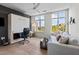 Versatile bedroom area featuring a murphy bed, work space, comfortable seating, and natural light at 618 N Boylan Ave # 810, Raleigh, NC 27603