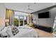 Bedroom with balcony access, ceiling fan, gray accent wall and hardwood floors at 618 N Boylan Ave # 810, Raleigh, NC 27603