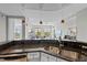Kitchen featuring granite countertops, stainless steel sink, and view of the living room at 618 N Boylan Ave # 810, Raleigh, NC 27603
