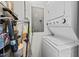 Compact laundry room featuring a stacked washer and dryer, shelving, and essential utility components at 618 N Boylan Ave # 810, Raleigh, NC 27603