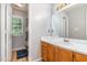 Bathroom featuring white sink, wooden vanity, large mirror, and a shower/tub with a decorative curtain at 628 Kankakee Ct, Knightdale, NC 27545