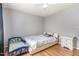 Cozy bedroom with light hardwood floors, ceiling fan and natural light, featuring a double bed and decor at 628 Kankakee Ct, Knightdale, NC 27545