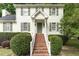 Traditional home with brick steps, white railing and green shutters creating a warm and inviting facade at 628 Kankakee Ct, Knightdale, NC 27545