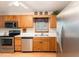 Efficient kitchen with stainless steel appliances, wood cabinets, and a double sink at 628 Kankakee Ct, Knightdale, NC 27545