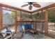 Relaxing sunroom with screened windows, wicker seating, a ceiling fan, and views of the outdoors at 628 Kankakee Ct, Knightdale, NC 27545