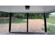 View of the covered back porch with an open view of the backyard and greenery at 65 Prospect Church Rd, Erwin, NC 28339