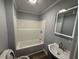 Clean bathroom offers a tub/shower combination, a modern sink vanity, and an updated LED mirror at 65 Prospect Church Rd, Erwin, NC 28339
