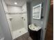 Modern bathroom showcasing tiled shower, vanity with LED mirror, and attractive fixtures at 65 Prospect Church Rd, Erwin, NC 28339