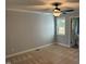 This bedroom features carpet, light gray walls, white trim, ceiling fan and a window at 65 Prospect Church Rd, Erwin, NC 28339