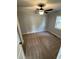 This bedroom features carpet, light gray walls, white trim, ceiling fan and a window at 65 Prospect Church Rd, Erwin, NC 28339