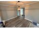 The dining room has light gray walls, wood-look flooring, white trim and a modern chandelier at 65 Prospect Church Rd, Erwin, NC 28339