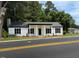 Charming single-story home featuring a covered front porch, black shutters, and fresh landscaping at 65 Prospect Church Rd, Erwin, NC 28339