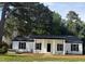 Charming single-story home featuring a covered porch with stately columns and black shutters at 65 Prospect Church Rd, Erwin, NC 28339
