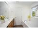 Bright bathroom features a soaking tub, large window, and vanity with counter space at , Knightdale, NC 27545