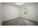 A bright bedroom with neutral walls, carpet flooring, and a single window at , Knightdale, NC 27545