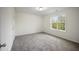 Bedroom featuring neutral walls, carpet flooring, and a single window with a view of greenery at , Knightdale, NC 27545
