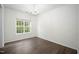 Sunlit bedroom with hardwood floors, a chandelier and a large window at , Knightdale, NC 27545