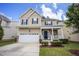 Charming two-story home featuring a manicured lawn, attached two-car garage, and inviting front porch at , Knightdale, NC 27545