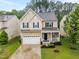 Beautiful two-story home showcasing an attached garage, a welcoming front porch, and professionally landscaped front yard at , Knightdale, NC 27545