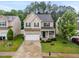Aerial view of the home's front elevation and manicured front yard with two car garage at , Knightdale, NC 27545