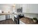 Modern kitchen with stainless steel appliances, white cabinets, and granite countertops at , Knightdale, NC 27545