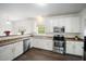 Bright kitchen featuring stainless steel appliances, white cabinets, and modern fixtures at , Knightdale, NC 27545