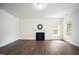 Spacious living room with fireplace, large window, and hardwood floors at , Knightdale, NC 27545