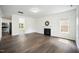 Bright living room with dark wood floors, a fireplace and large windows at , Knightdale, NC 27545