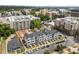 Aerial view of stylish townhomes featuring manicured lawns, set against a cityscape with verdant trees and clear sky at 710 W North St # 103, Raleigh, NC 27603