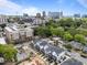 Bright aerial shot showcases modern townhomes amid an urban setting, complete with a clear blue sky and construction site at 710 W North St # 103, Raleigh, NC 27603